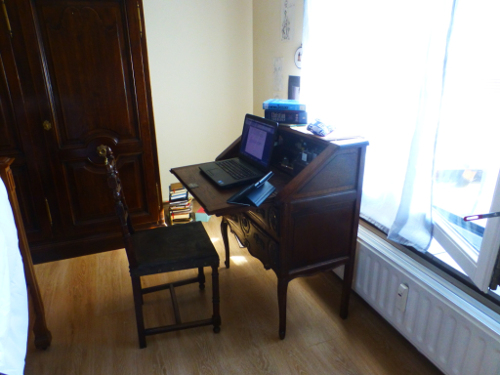 Antique desk with laptop and theology books